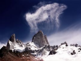 Tall rock and clouds Wallpaper