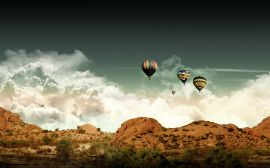 Balloons over hills Wallpaper